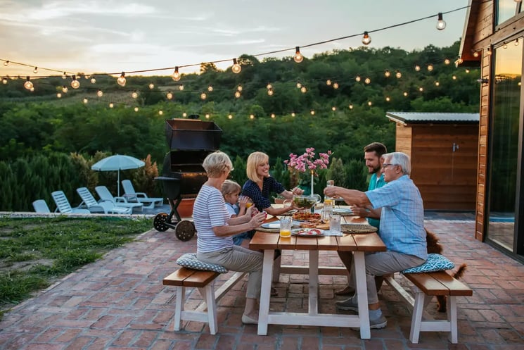 A group of people having dinner in a garden