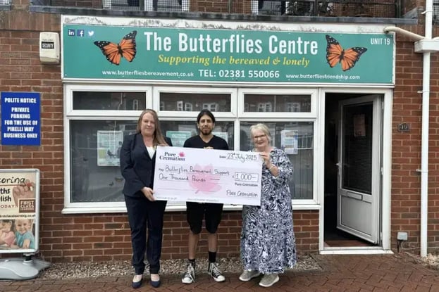 Steph from Pure presenting a large cheque