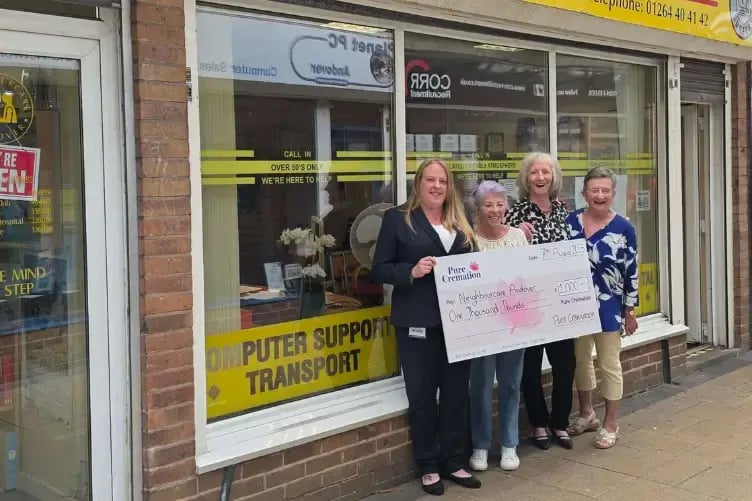 The Pure team presenting a cheque to the Neighbourcare Team Team