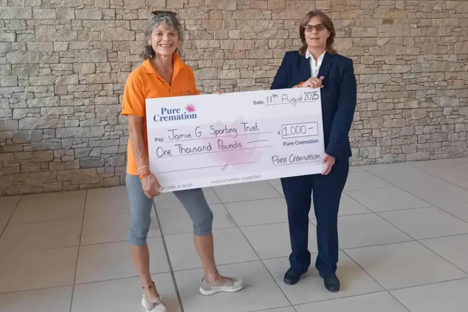 Jay from Pure presenting a cheque to the Jamie G Sporting Trust