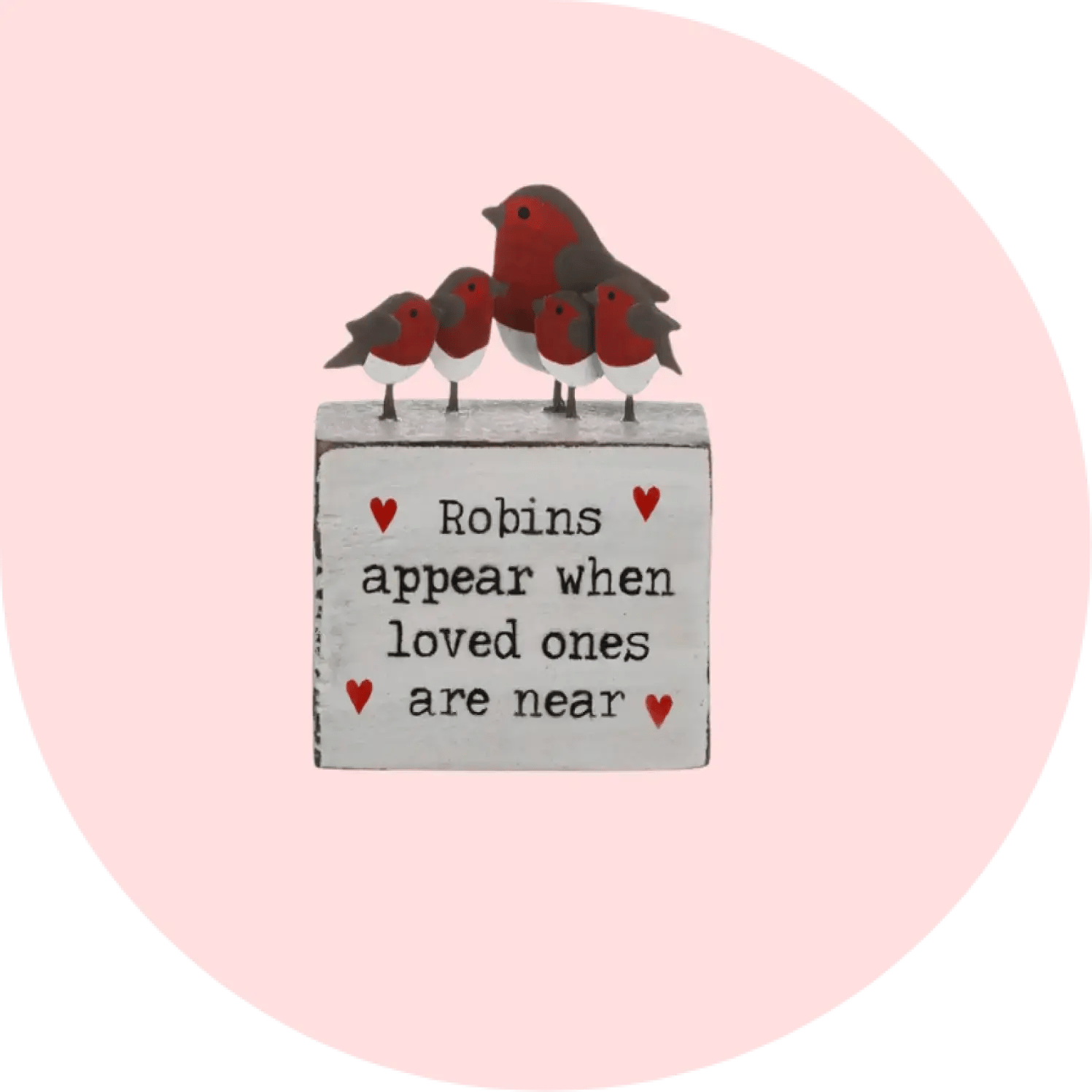 A block with one large and four small robins on top