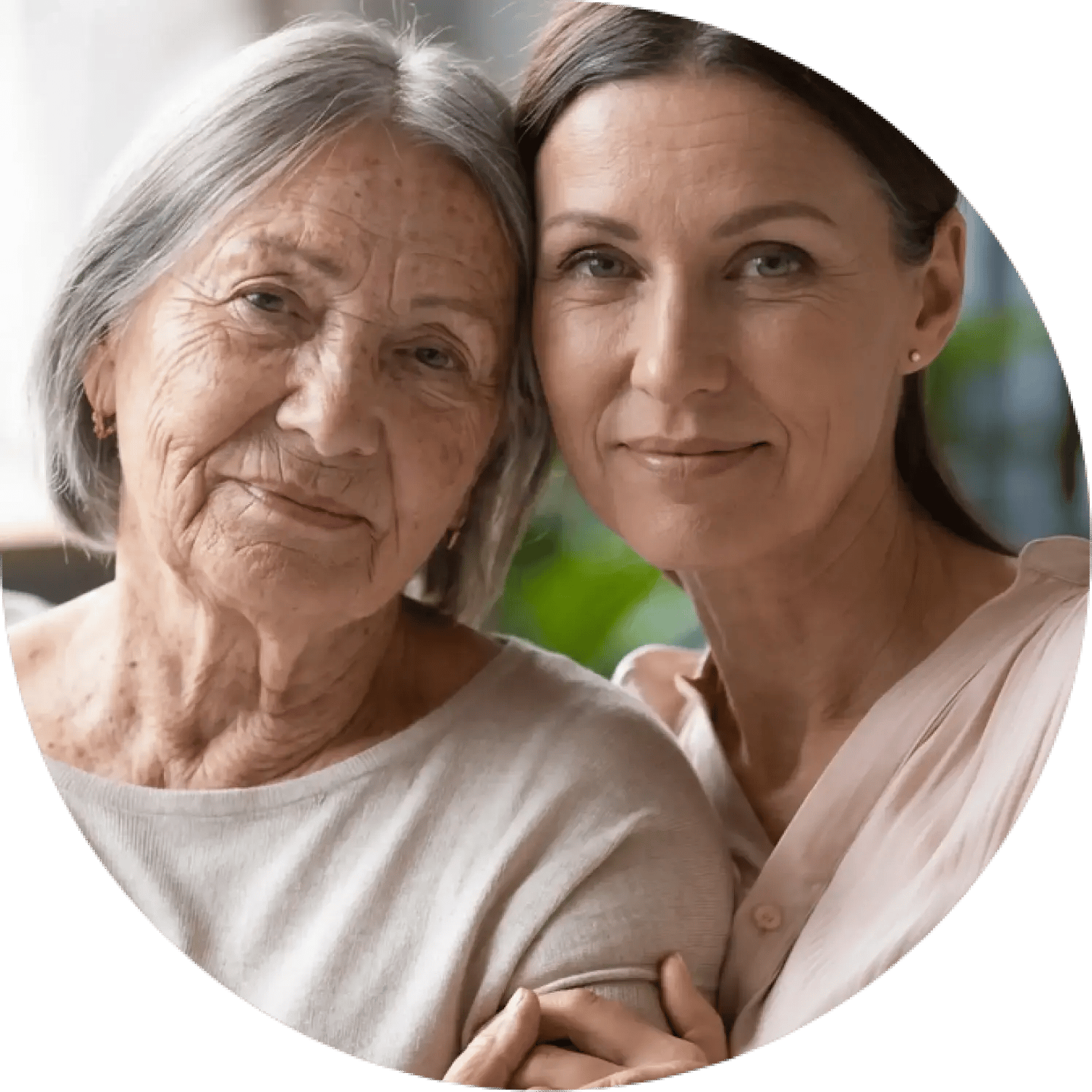 Two women looking at the camera, slightly smiling