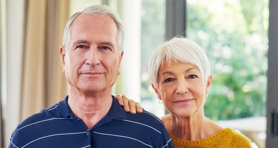 A man and woman looking at the camera