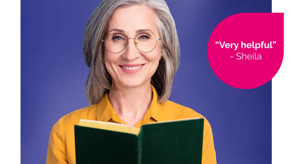 A smiling woman holding a green book
