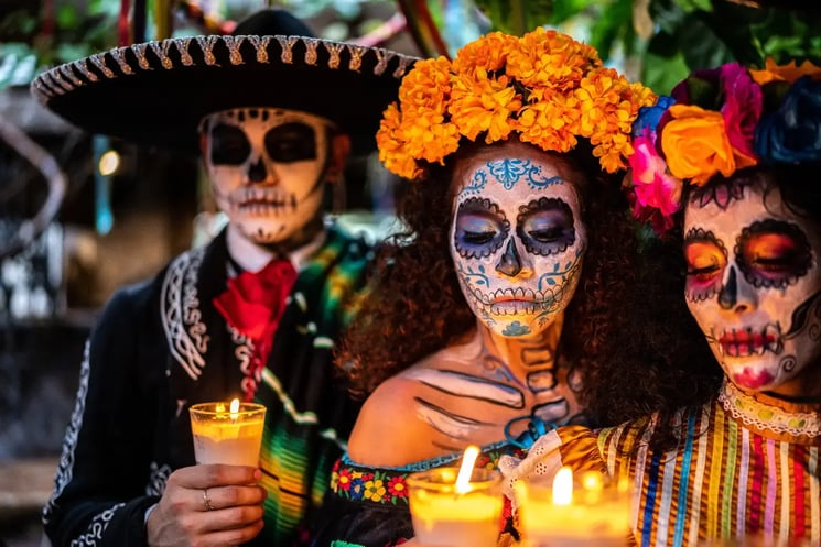 Three people with face paint for the Day of the Dead