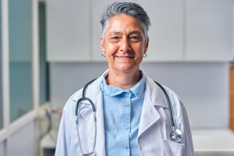 A doctor looking into the camera, smiling slightly 