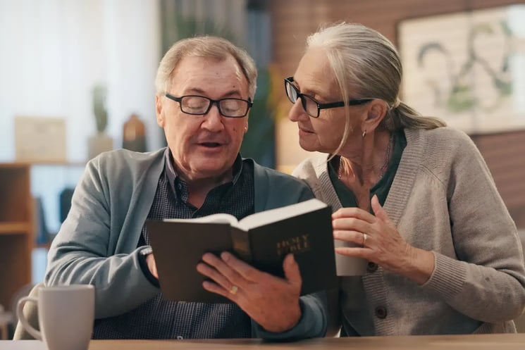 A man and woman reading The Bible