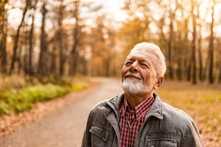 A man in the forest, taking in the fresh air