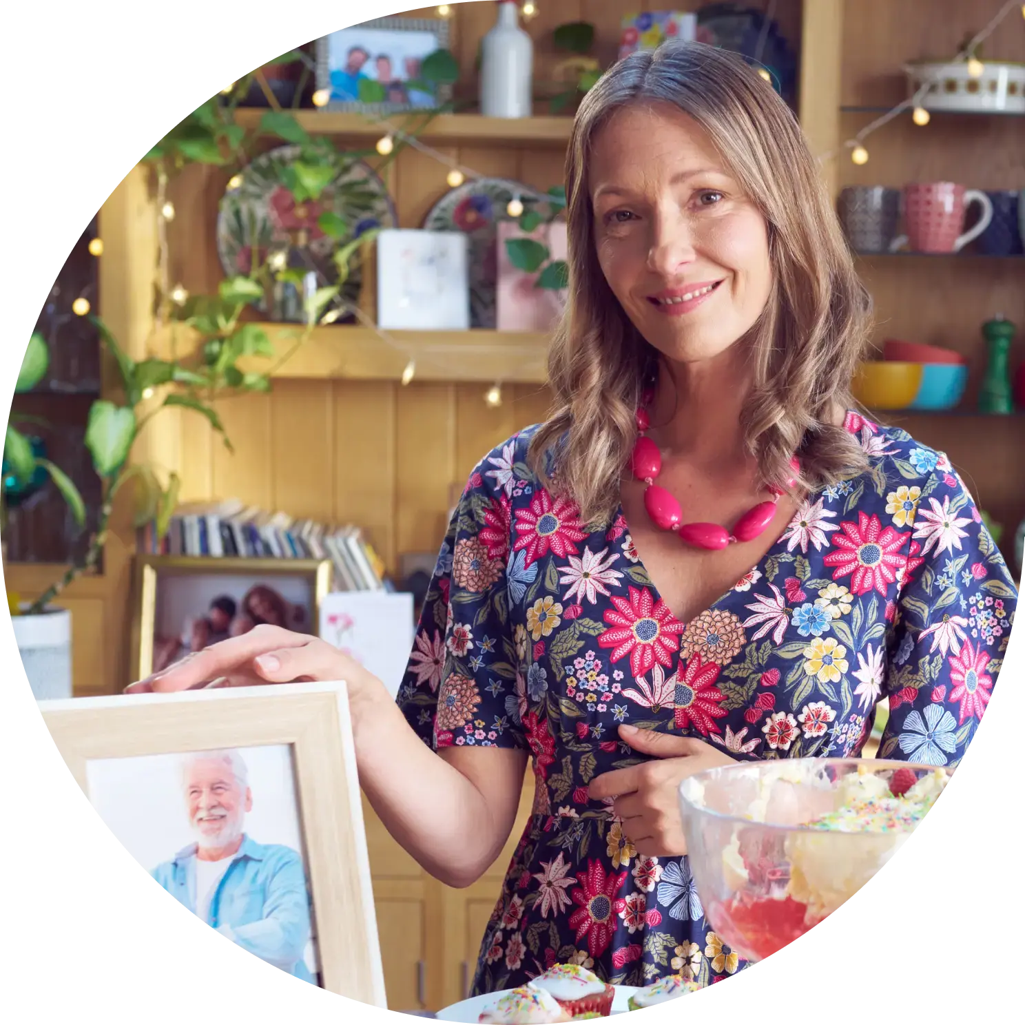 A smiling woman shows a photo of her husband A smiling woman shows a photo of her husband